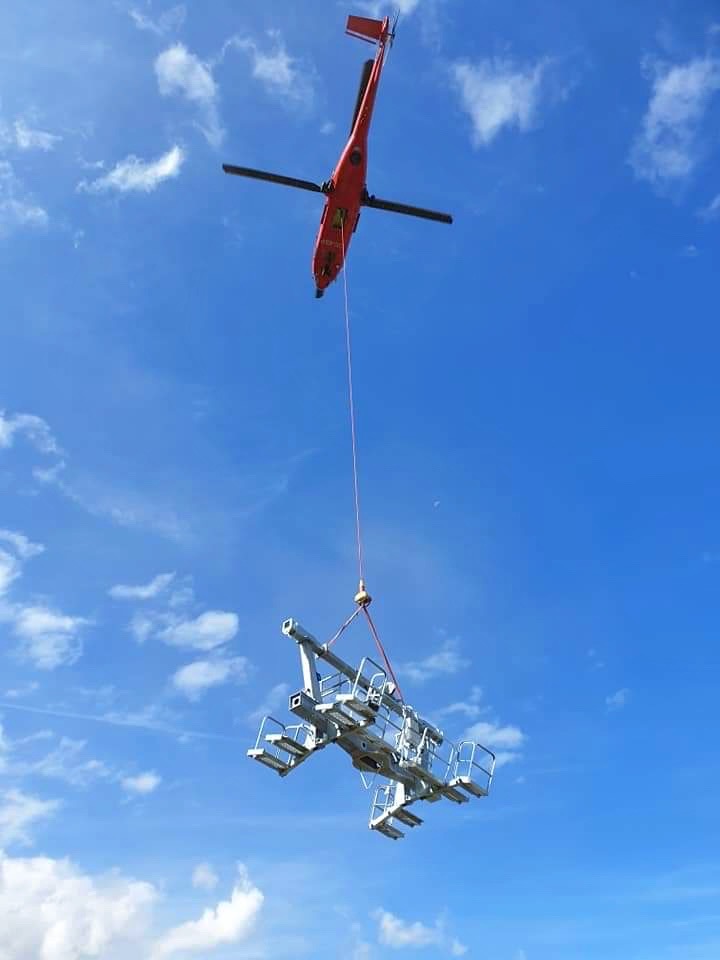 Helicopter delivering gantry to pylons on the new Arpettaz chairlift in Sainte Foy